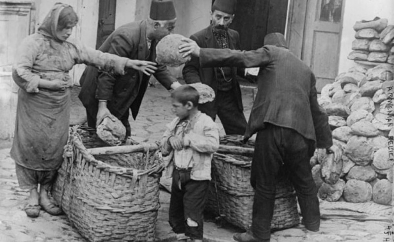 Armenian refugee women and child getting food relief, 1915-16, Library of Congress.
